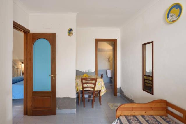 a room with a table and a dining room at Azzurromare Residence in Procida