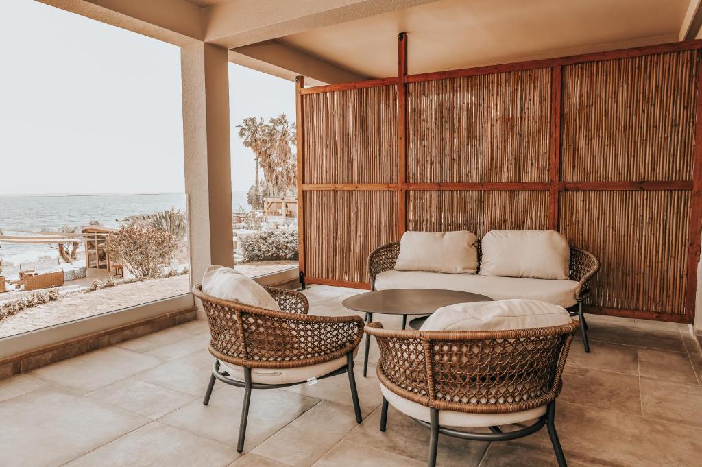 a balcony with a table and chairs and a couch at Sagredo Boutique Hotel & Spa in Ágios Fokás
