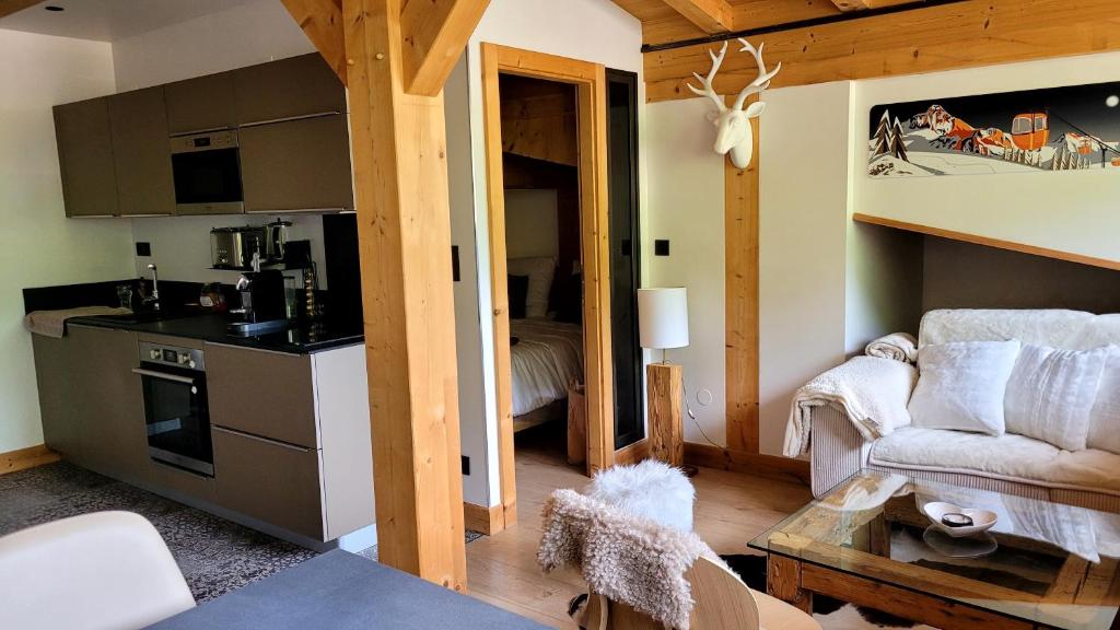 a room with a kitchen and a living room at Roof top Moutain view direct access Morzine Avoriaz in Montriond