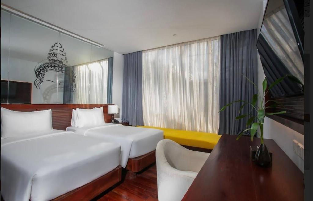 Postel nebo postele na pokoji v ubytování UTEY Hotel