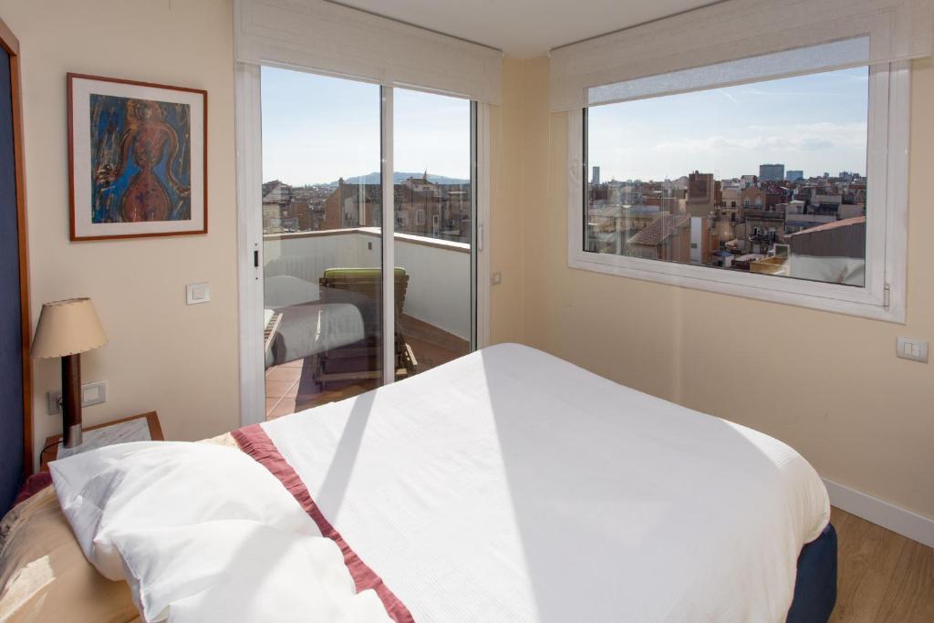 A bed or beds in a room at Gaudi Views Apartment