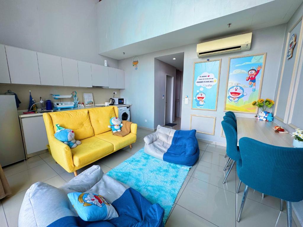 a living room with a yellow couch and a table at Doraemon I-City House, Hyde Tower I-City, Seksyen 7, Shah Alam, Selangor in Shah Alam