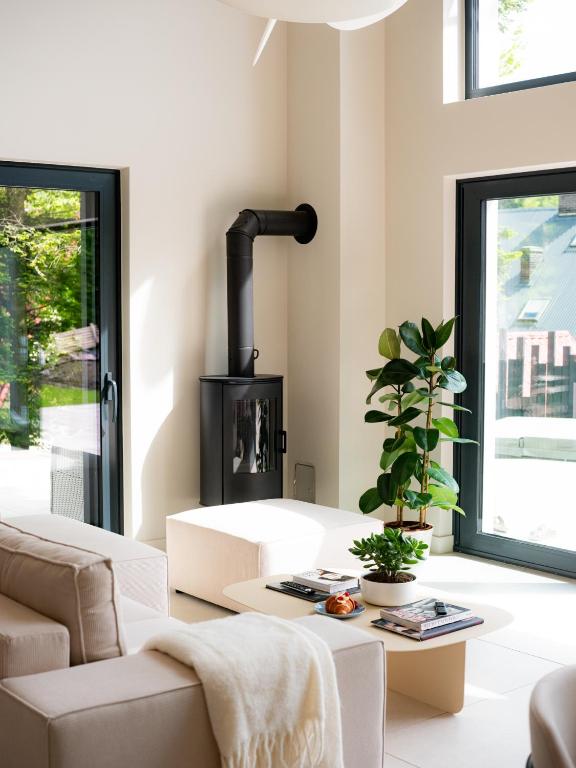 a living room with a couch and a stove at Babiogórska Stodoła in Zawoja