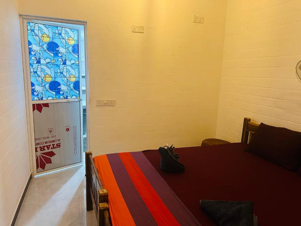 Postel nebo postele na pokoji v ubytování Pearl Bungalow Trincomalee