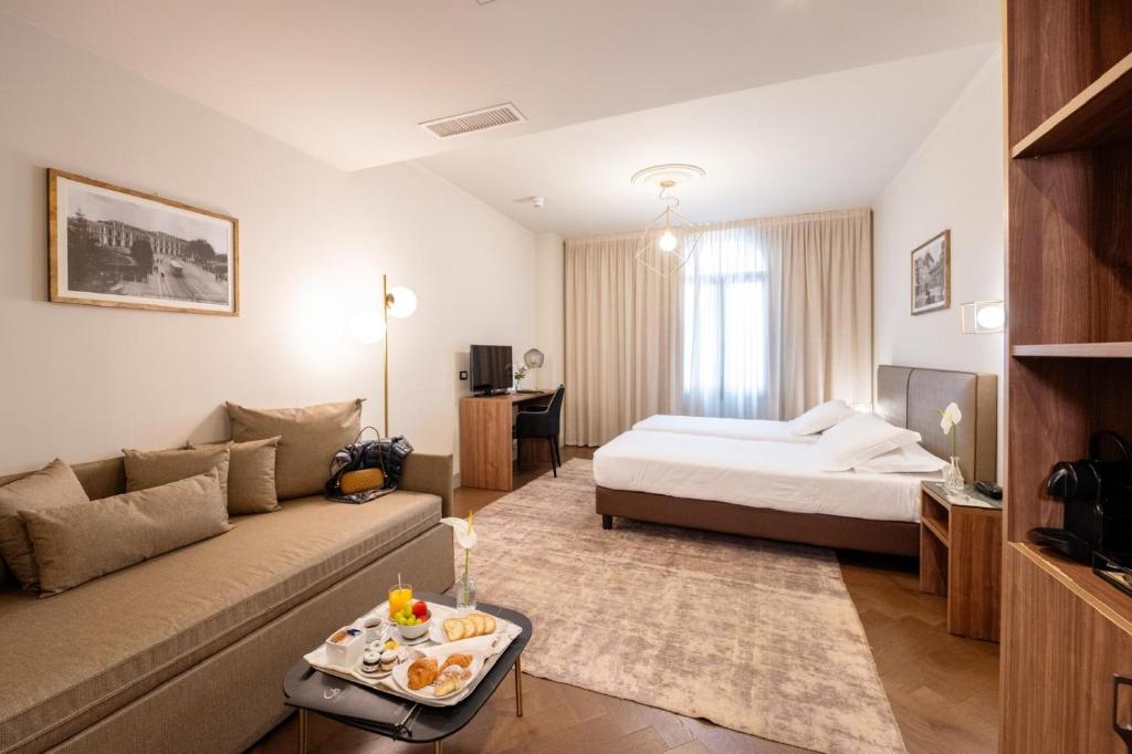 Postel nebo postele na pokoji v ubytování Porta Altinia Suites