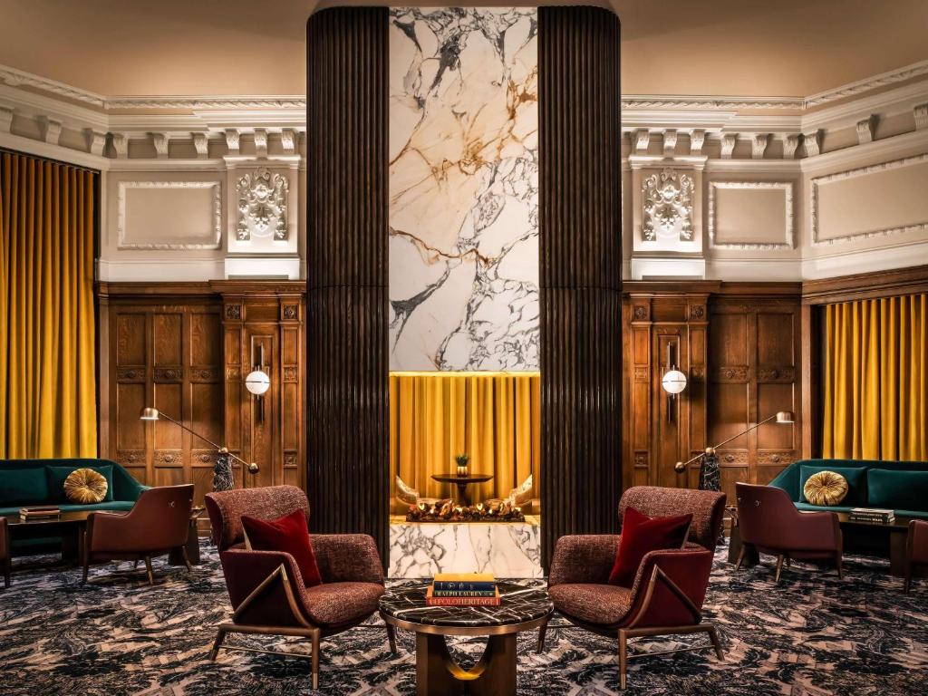 a lobby of a hotel with chairs and a wall at Fairmont Chateau Laurier in Ottawa