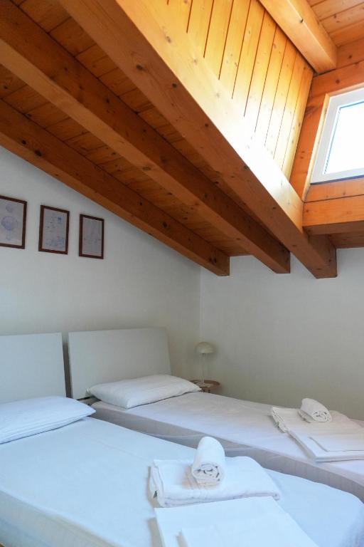 Łóżko lub łóżka w pokoju w obiekcie Dainese Apartments, Casa Abigail