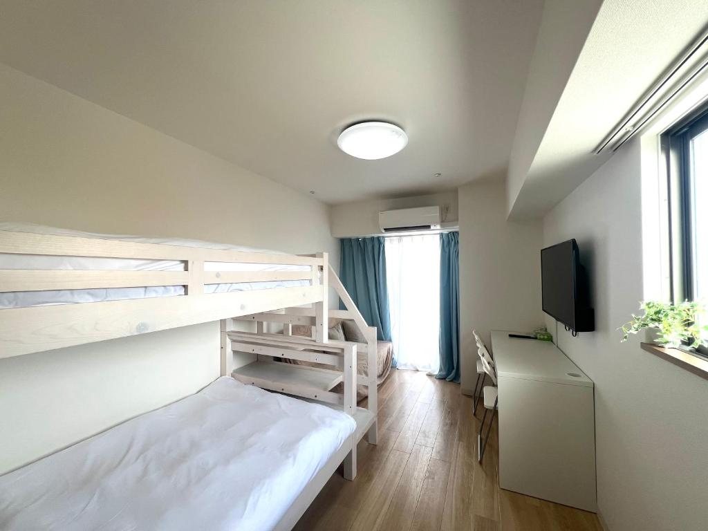 Postel nebo postele na pokoji v ubytování Suke Home Oshiage