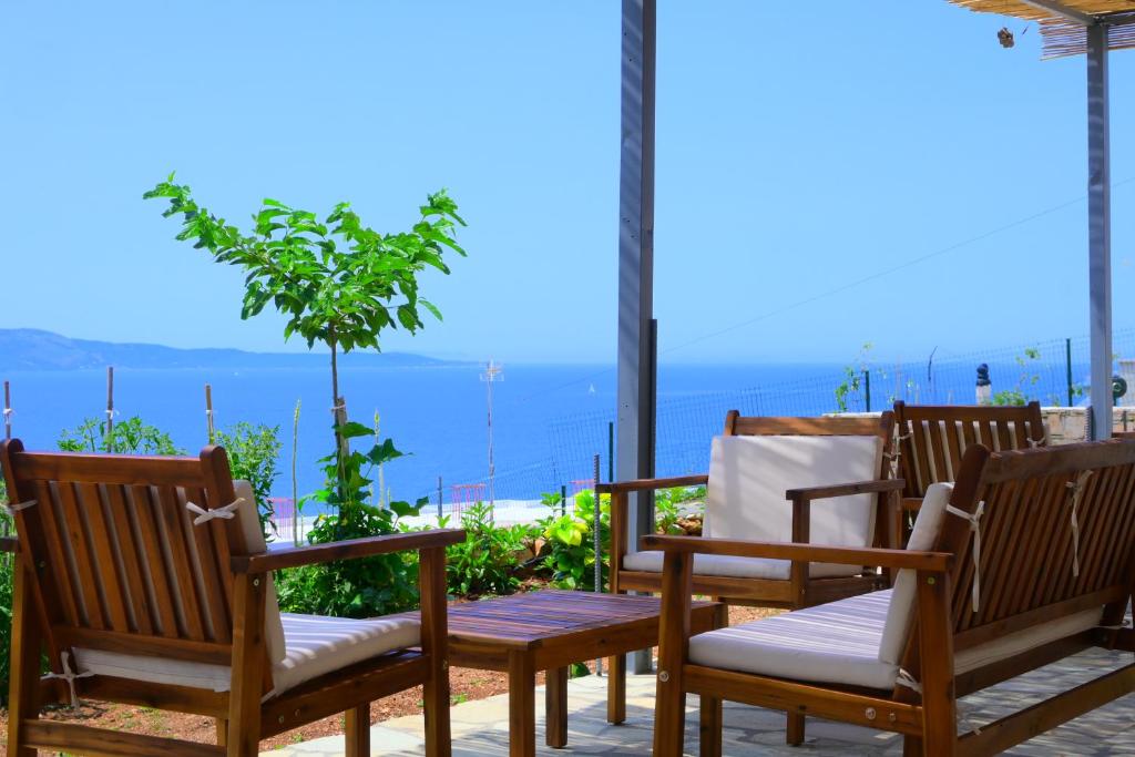a group of chairs sitting on a patio with a view at Summer Dream Cottage in Ksamil