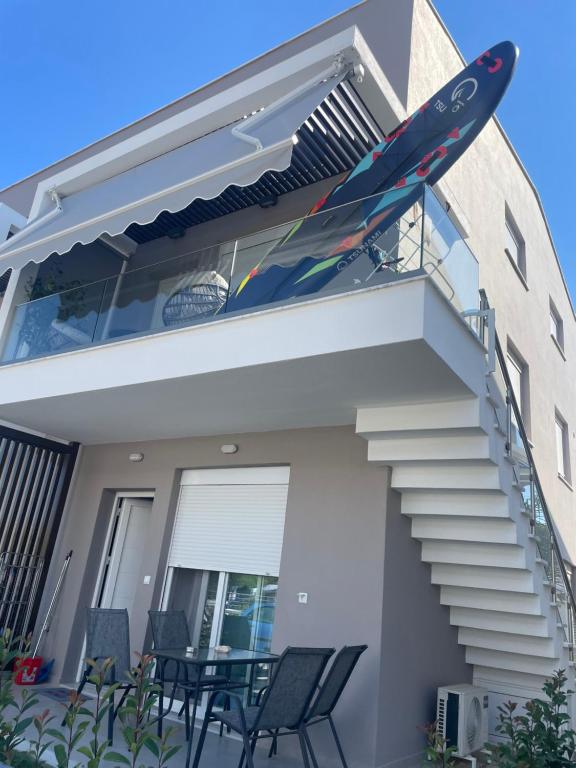 a surfboard sitting on the side of a house at Anastasia B in Ofrínion