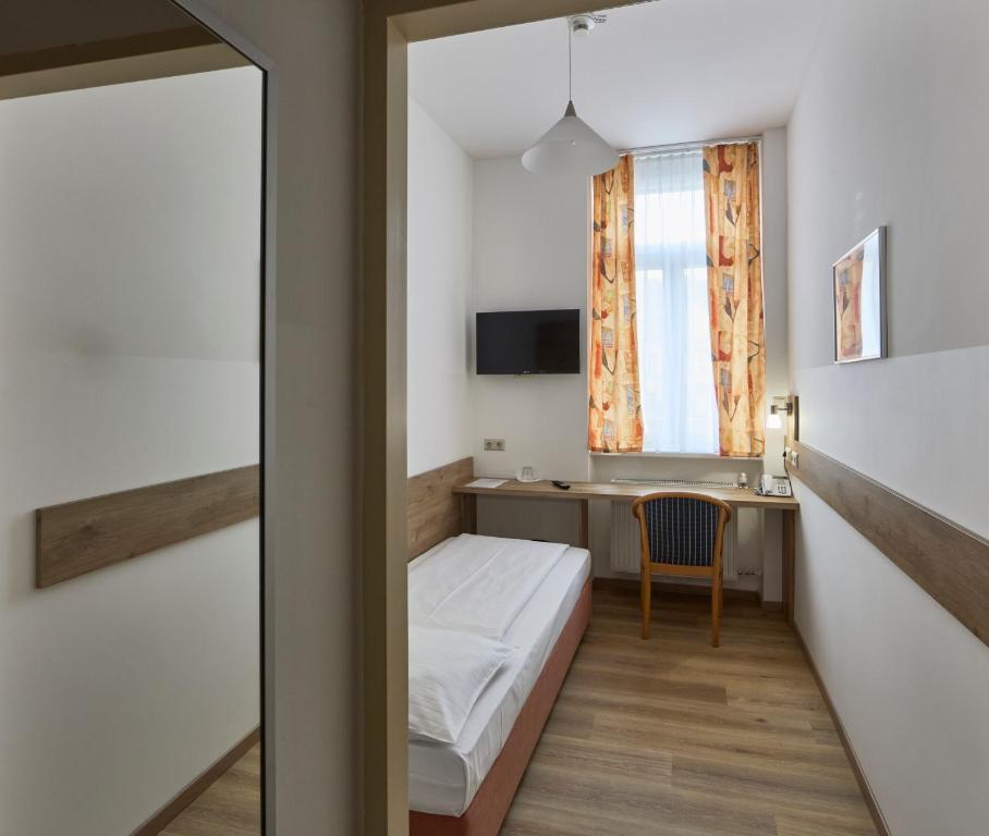 Postel nebo postele na pokoji v ubytování Hotel Terminus