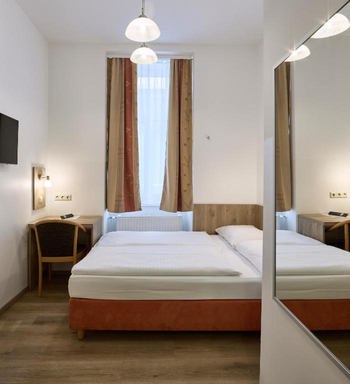 Postel nebo postele na pokoji v ubytování Hotel Terminus