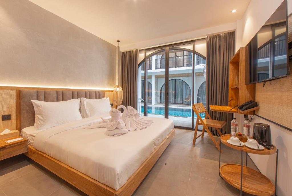 Postel nebo postele na pokoji v ubytování Suites5 Hotel