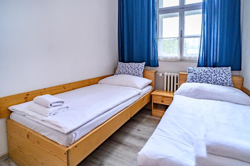 Postel nebo postele na pokoji v ubytování Penzion u Hradilů