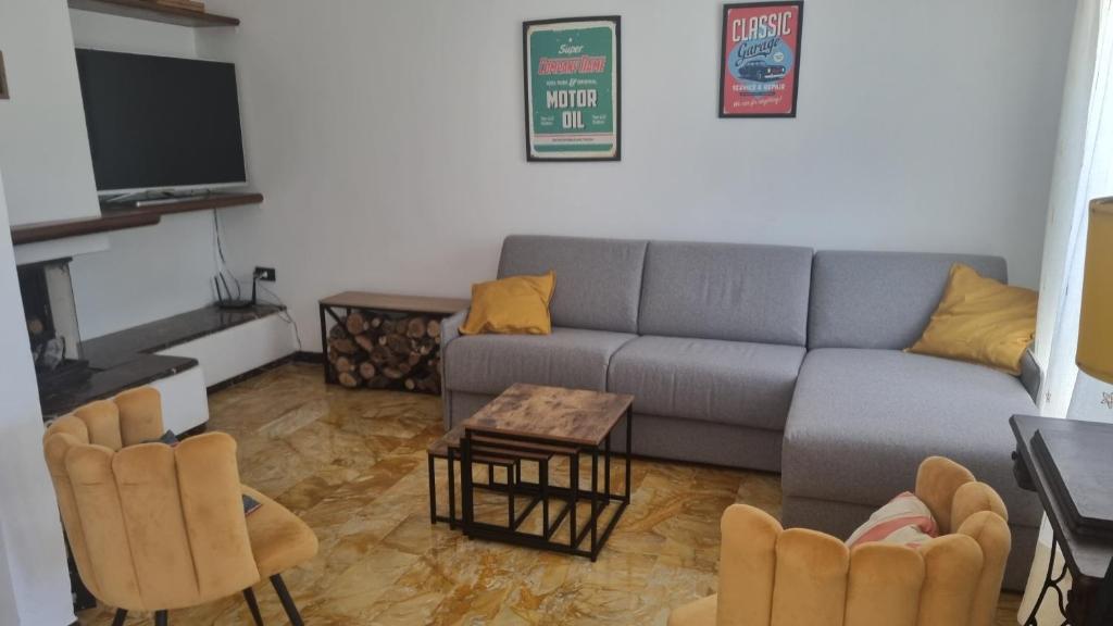 a living room with a couch and a table and chairs at Wildflowers House - JApartments in Genova