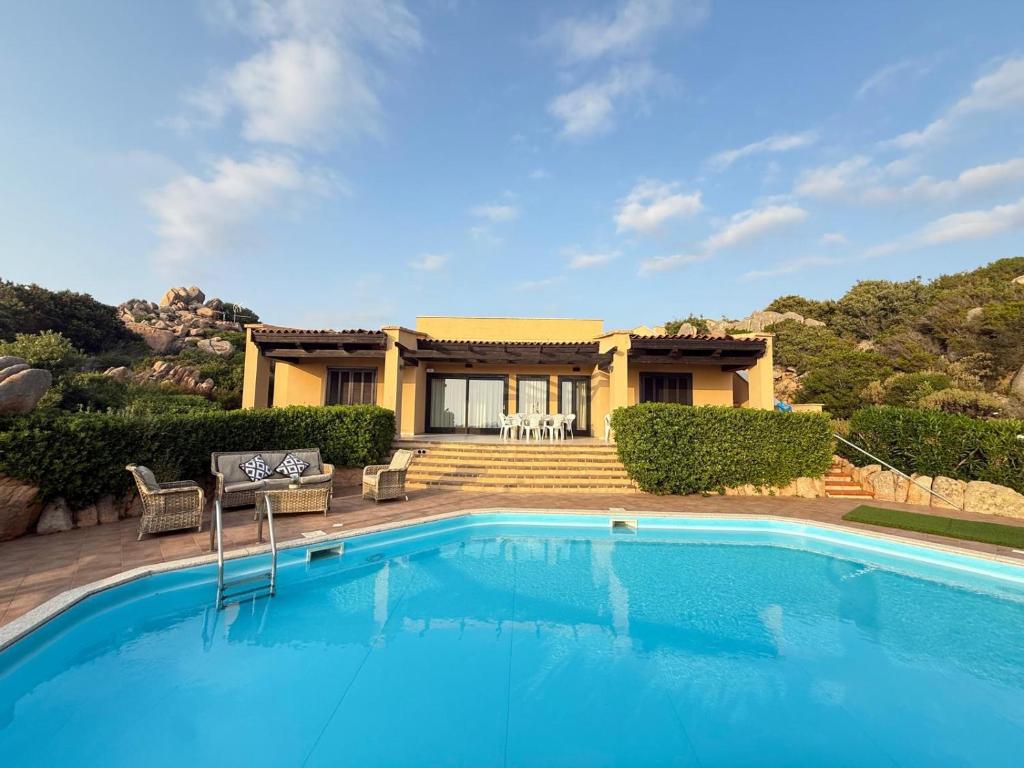 a house with a swimming pool in front of a house at Villa Blue Horizon in Costa Paradiso