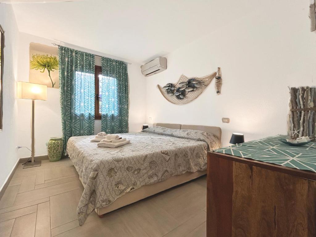 A bed or beds in a room at Deluxe Apartments in Porto Rotondo