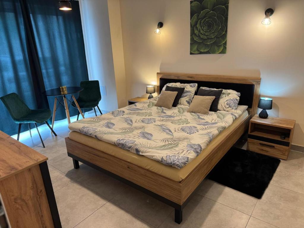 a bedroom with a bed with chairs and a table at The Peaceful Patio Apartment in Rzeszów