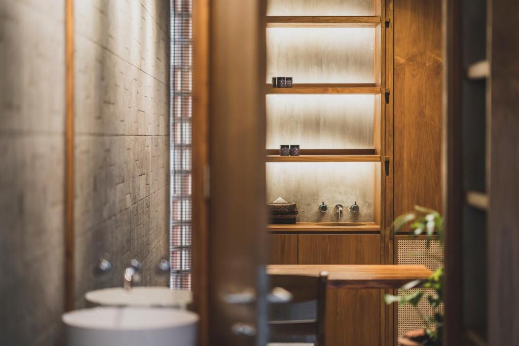 a bathroom with a sink and a window at Blossom Eco Luxe Villas by Ekosistem in Canggu
