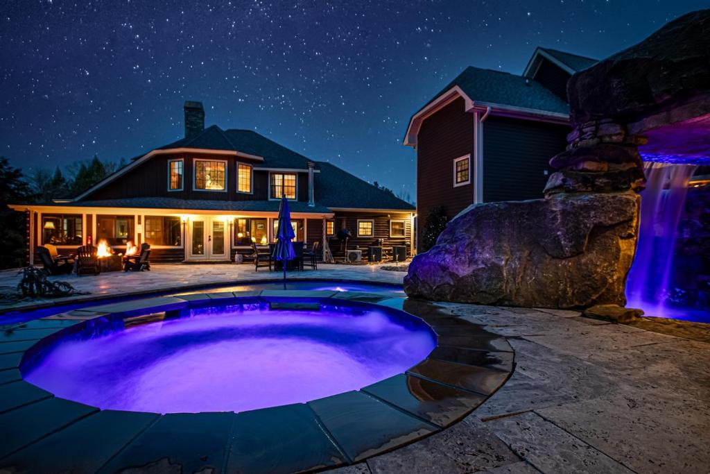 a backyard with a large pool at night at Backyard OasisHot Tub Fire PitWiFi5m to PF in Sevierville