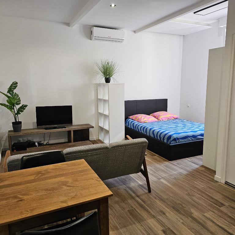 un salon avec un lit et un canapé dans l'établissement Chez Francis, Avignon Centre, à Avignon