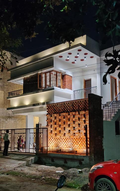 a house with a brick wall in front of it at One4ALL SALVIA in Chennai