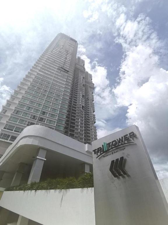 a tall building with a sign in front of it at Tritower Near CIQ Johor Bahru by JCHOME MWM in Johor Bahru