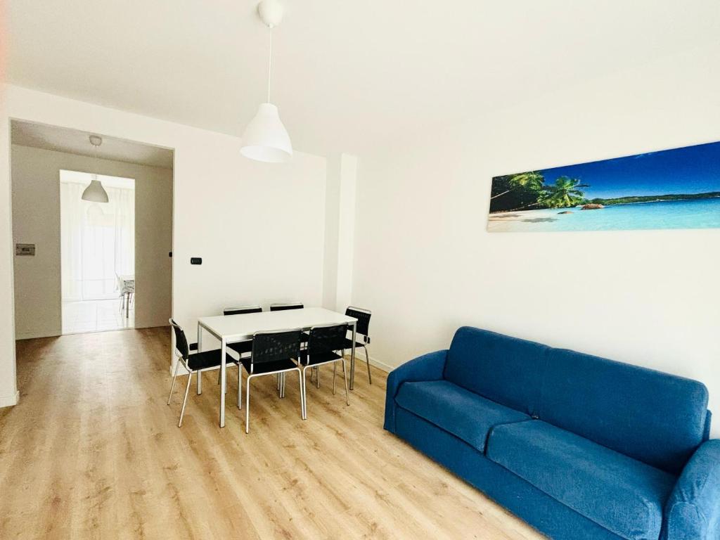 a living room with a blue couch and a table at Maredena - Comodo al centro e al Mare - Immobil Relax in Lido di Jesolo