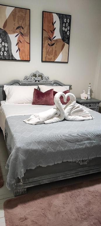 a bedroom with a bed with a swan on it at Lucato apartment in Florina