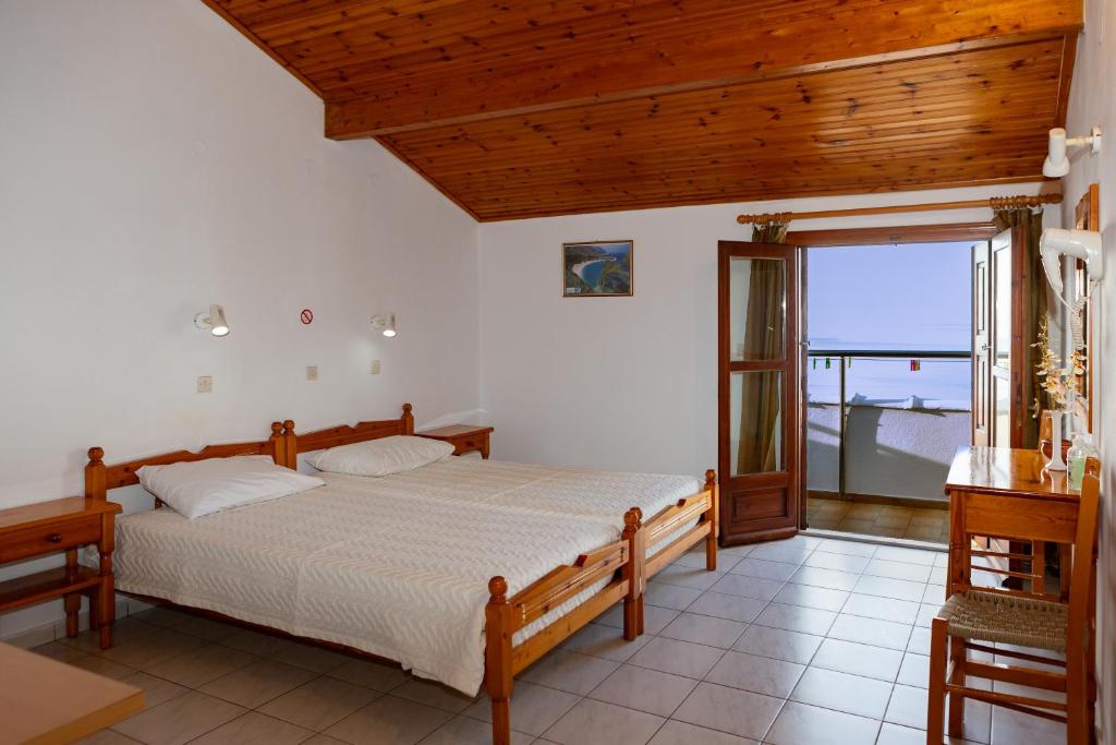 Postel nebo postele na pokoji v ubytování Lefteris Rooms