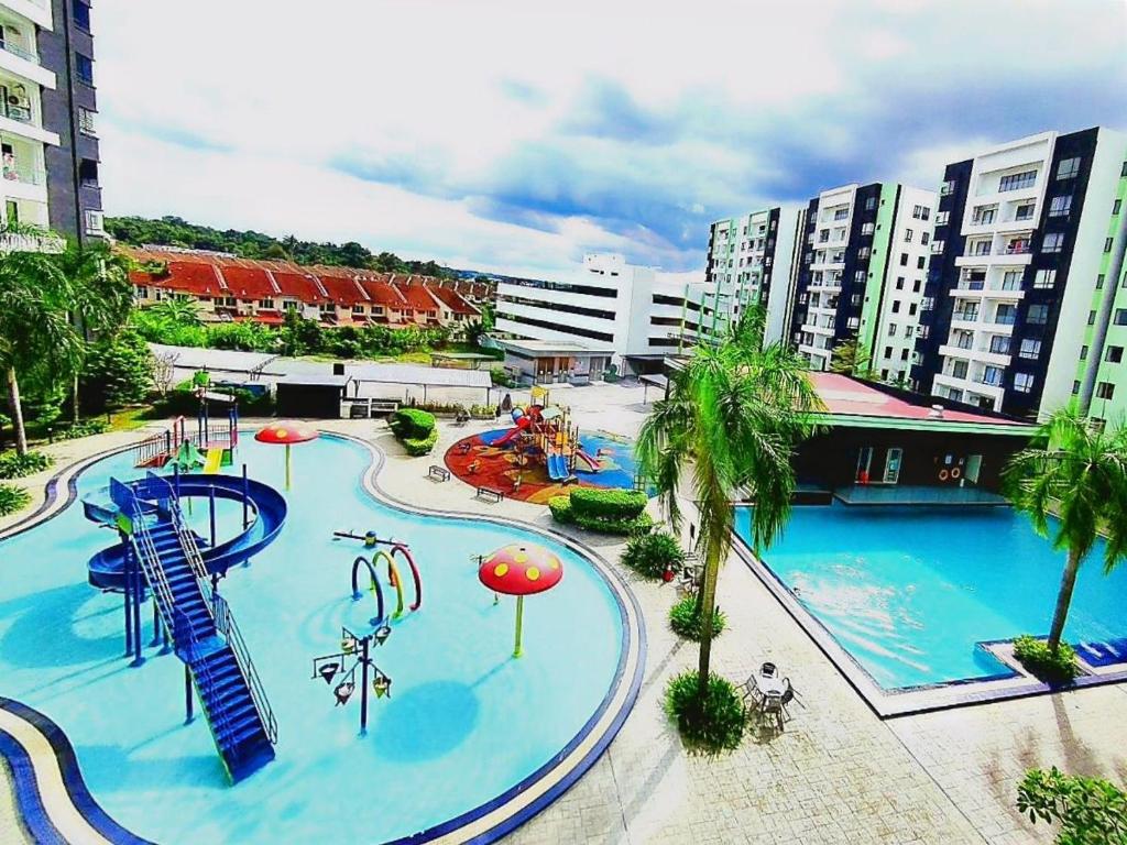 a large pool with a water park with a slide at Ipoh Manhattan Waterpark Suite by City Home Empire MHB403 in Ipoh