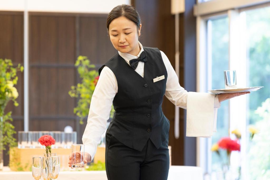Členové personálu v ubytování Kiryu Grand Hotel