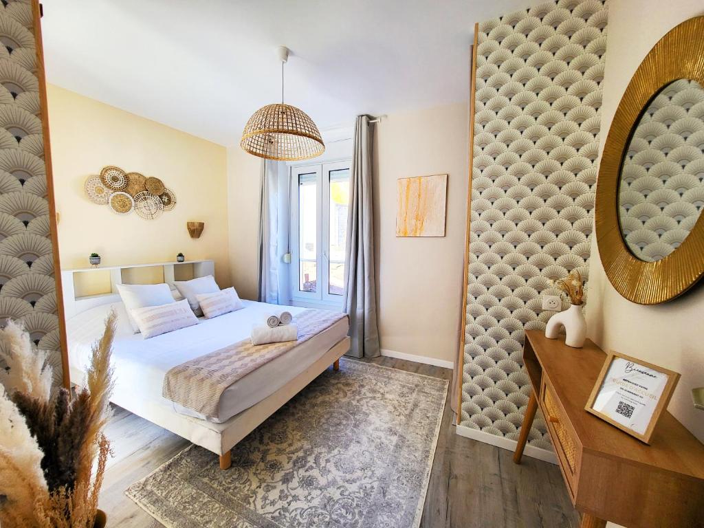 a bedroom with a bed and a mirror at Hacienda -A 2 min de la plage in Saint Malo