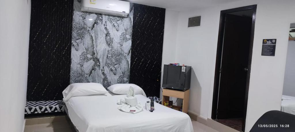Postel nebo postele na pokoji v ubytování Hotel Centrica Del Palo 45