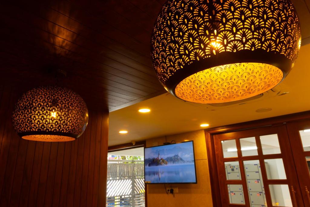 two lights hanging from the ceiling of a restaurant at The Viva Grand in Chennai