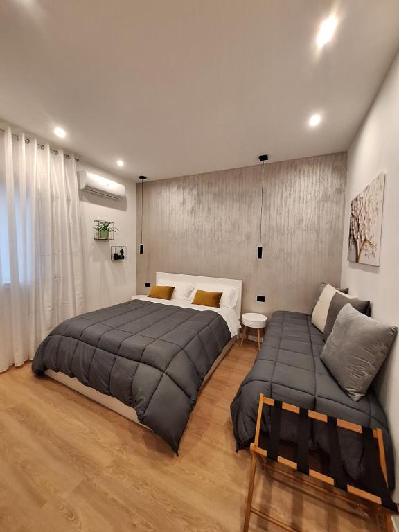 a bedroom with two beds and a couch at Dolce Luna in Agrigento