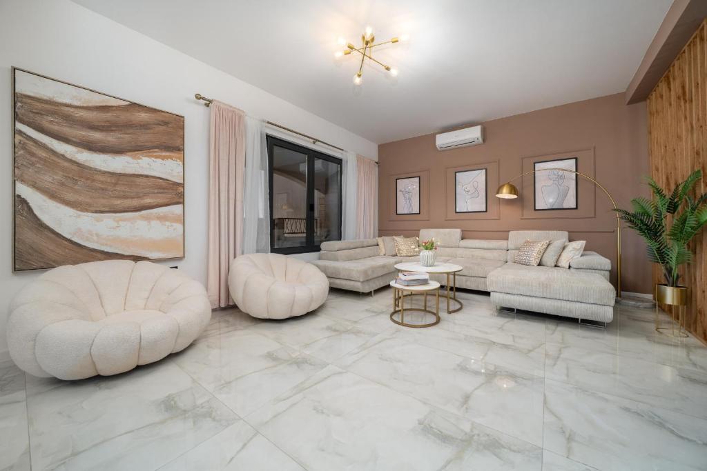 a living room with two white couches and a table at Luxury Dream House Nea with jacuzzi in Makarska