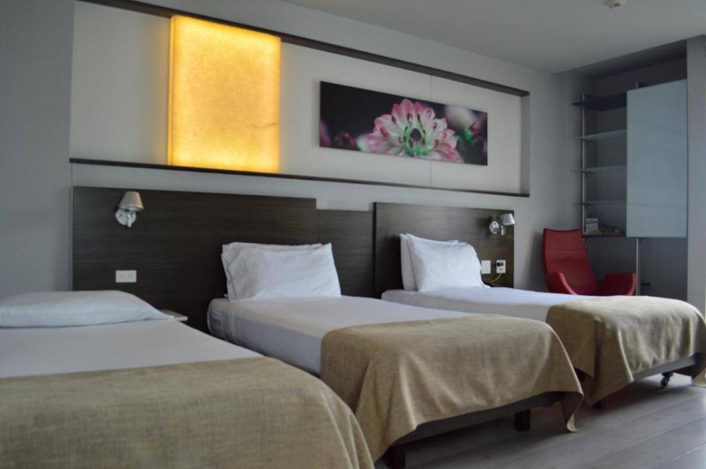 Postel nebo postele na pokoji v ubytování Inntu Hotel