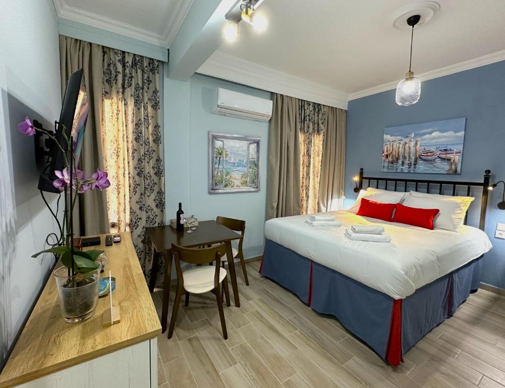 a bedroom with a bed and a desk and a table at Colorsphere in Thessaloniki