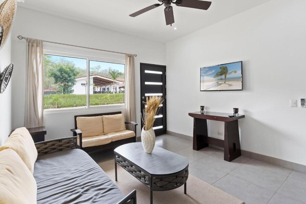 a living room with a couch and a table at Cozy 3BR Townhouse Near Tamarindo-2 Pool&More in Santa Cruz