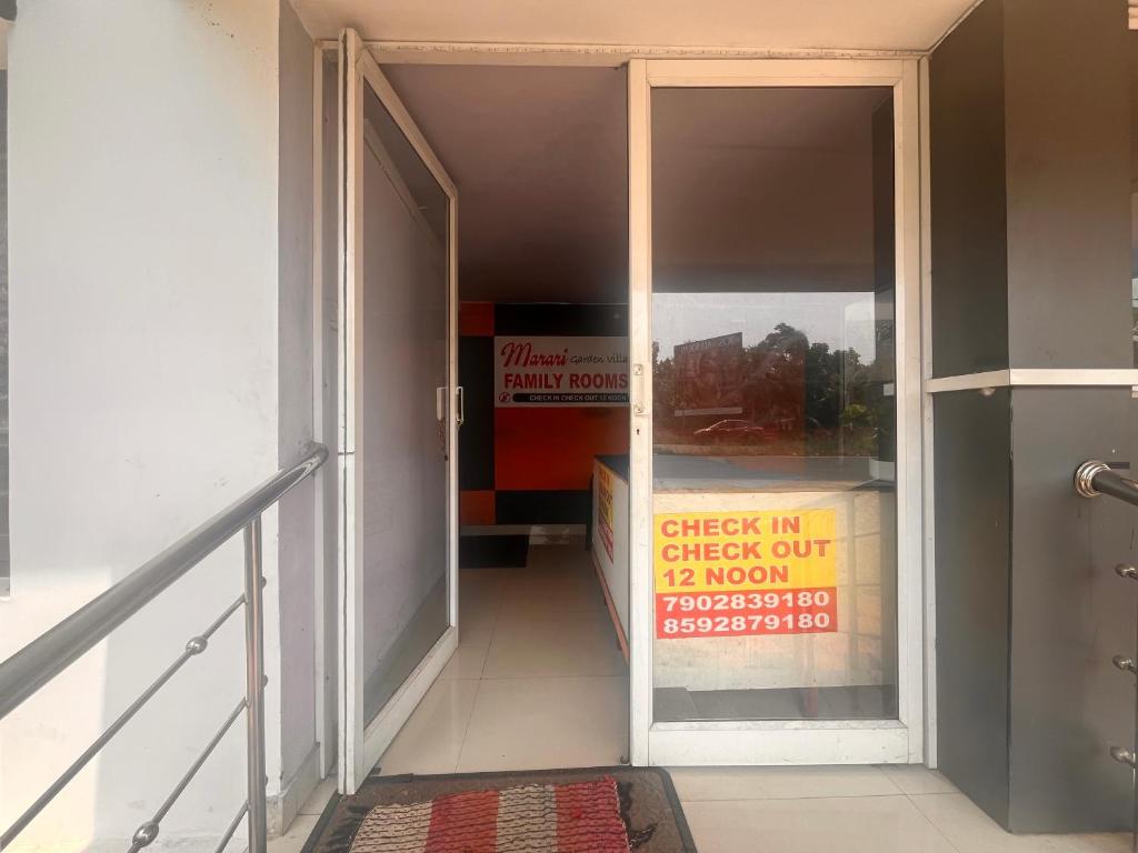 an open door with a sign in a building at Lulu holiday inn in Alleppey