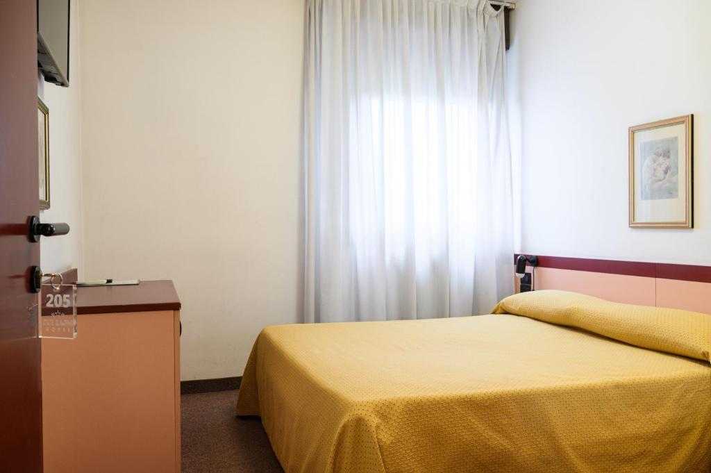 Postel nebo postele na pokoji v ubytování Hotel Due Ragni e Ristorante