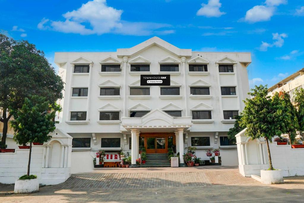 a white building with the front of it at Townhouse Oak Jaipur Arya Square Shopping Mall in Jaipur
