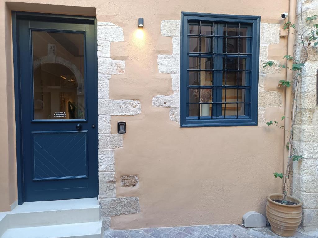 a house with a blue door and a window at Incentra in Chania