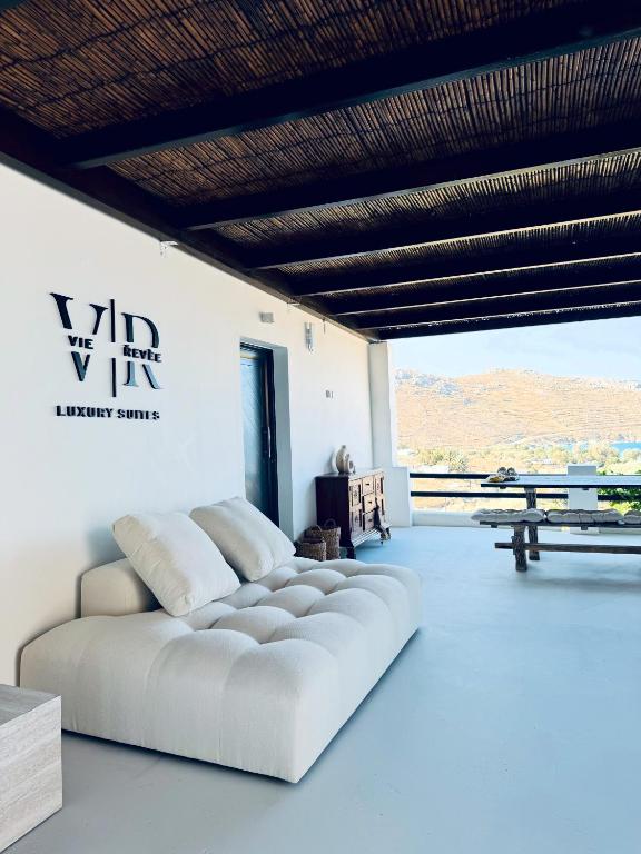 a white couch in a room with a table at Vie rêvée luxury suites in Ganema