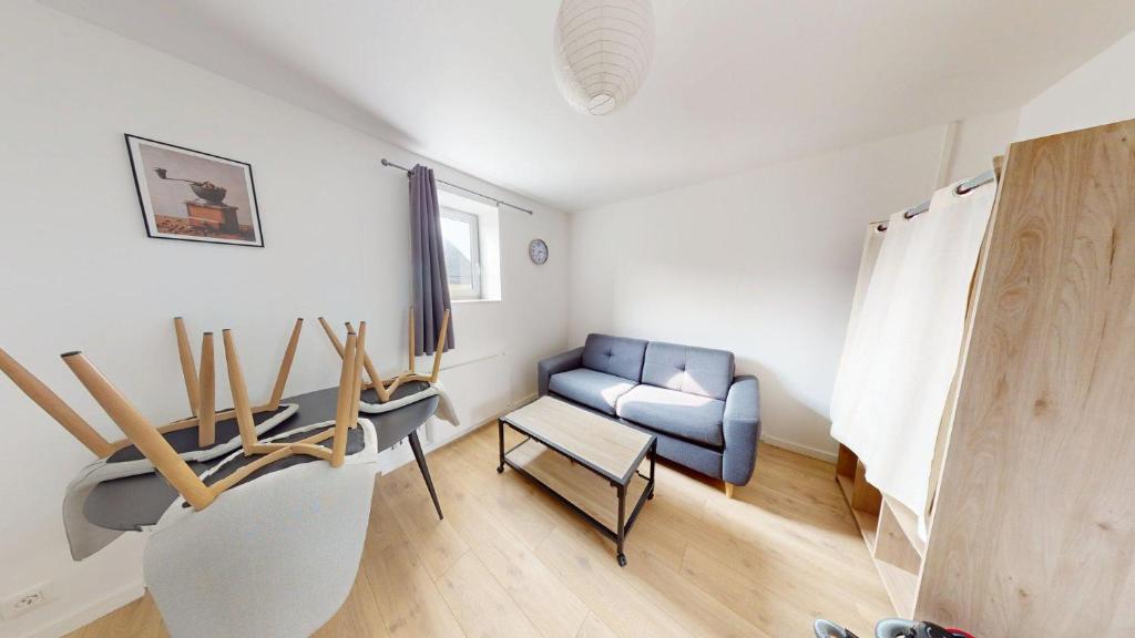 un salon avec un canapé et une chaise dans l'établissement 4ème étage, Général Sarrail, au Havre