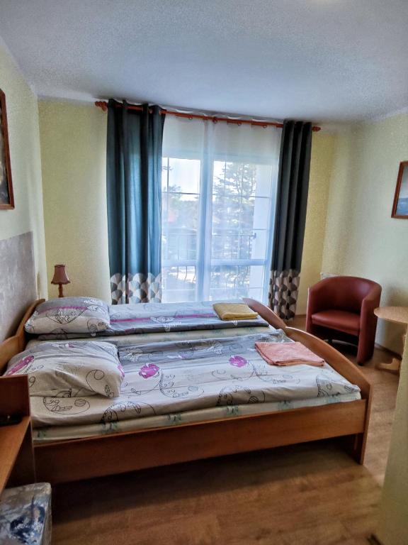 Postel nebo postele na pokoji v ubytování Michałek w Rowach