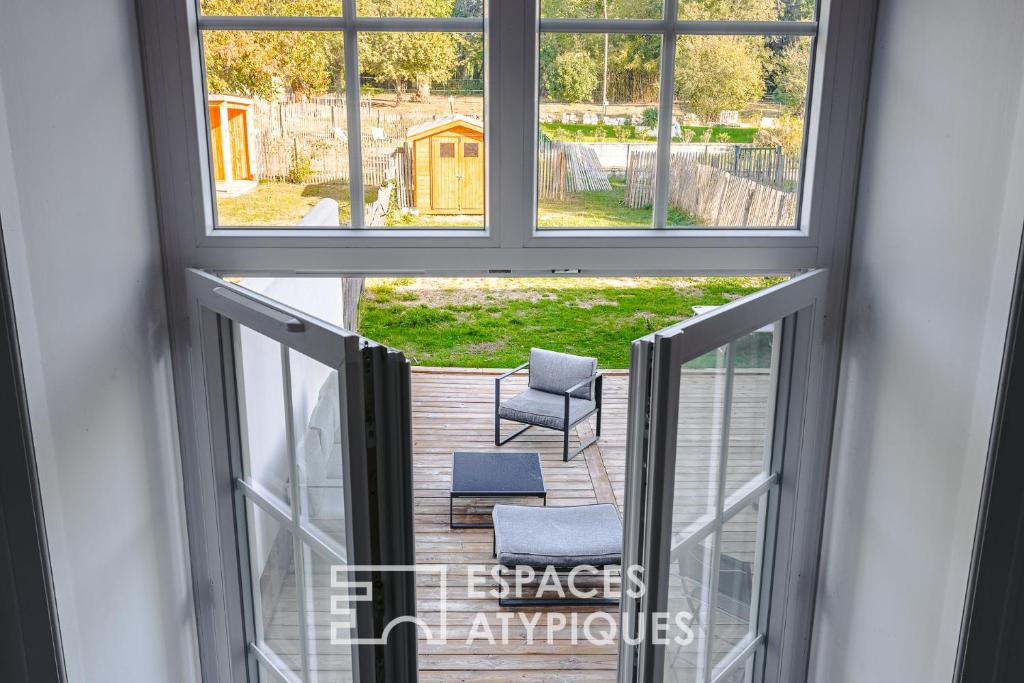 - un balcon avec 2 chaises et 2 fenêtres dans l'établissement Appartement avec jardin dans un château, à Lagord