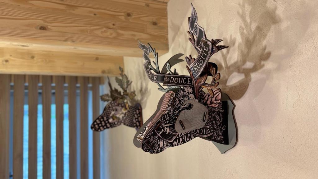 a cuckoo clock on the side of a wall at La Tana del Cervo del Maso K in Folgaria