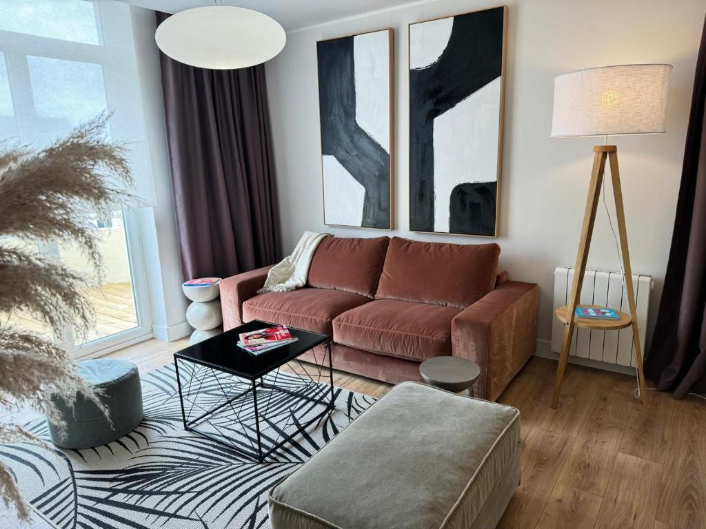 a living room with a couch and a table at Hélios Plage in Berck-sur-Mer